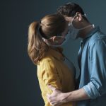 Young loving couple wearing face masks